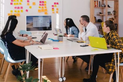 A team in an office discussing sales leadership during a meeting